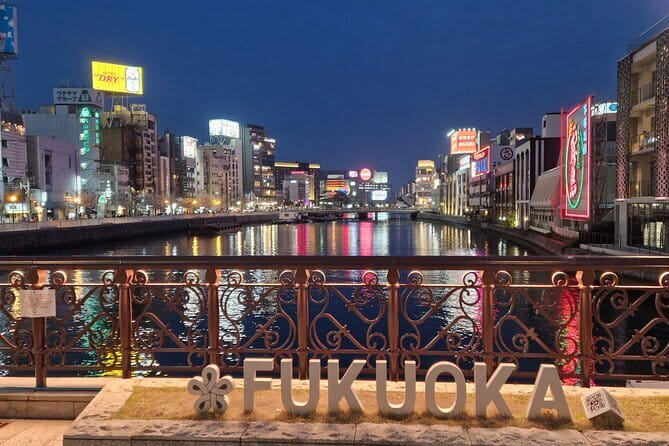 Fukuoka Evening Tours: Yatai, Izakaya, Karaoke and more - Entering Nakasu District, where neon and street food do the talking