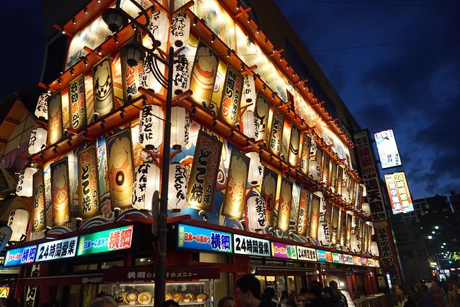 Osaka Local Foodie Walking Tour in Dotonbori and Shinsekai - Glico sign photos, then Sennichimae Doguyasuji for okonomiyaki